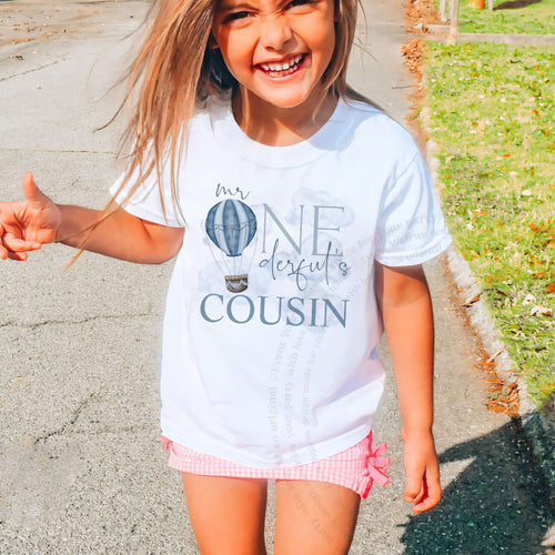 Laughing girl outdoors in a white Mr Onederful's Cousin kids tee.