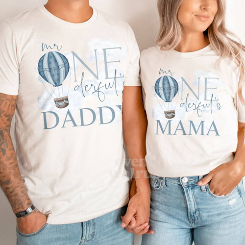 Dad and Mom holding hands in white Daddy and Mama Mr Onederful shirts.