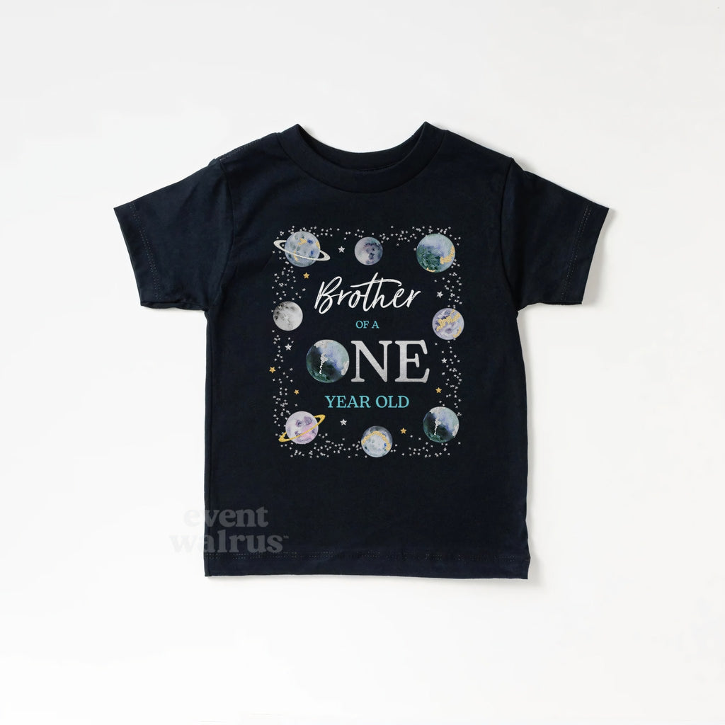 Black kids Brother of a ONE Year Old tee ringed with watercolor planets.