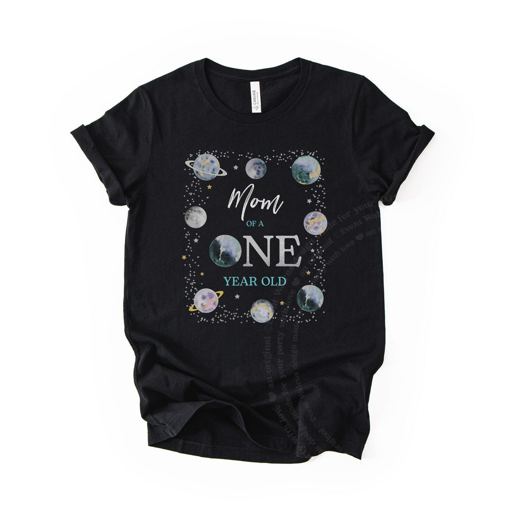 Black Mom of a ONE Year Old space tee with a planet for the O, laid flat.