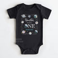 Black baby bodysuit reading Houston We Have a ONE Year Old with watercolor planets.