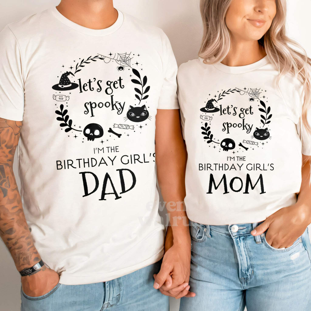 Dad and Mom holding hands in white Let's Get Spooky Dad and Mom shirts.