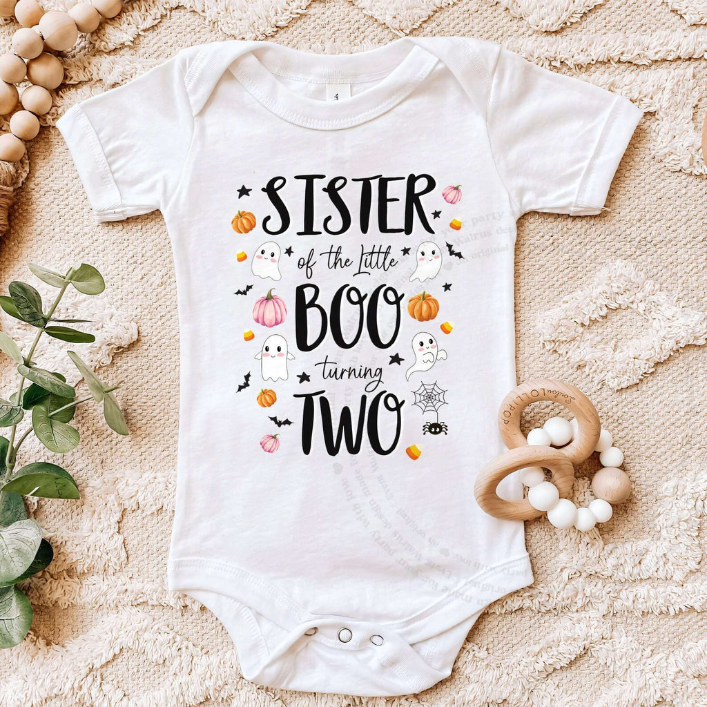 White Sister of the Little Boo bodysuit on a beige blanket with a wooden teether.
