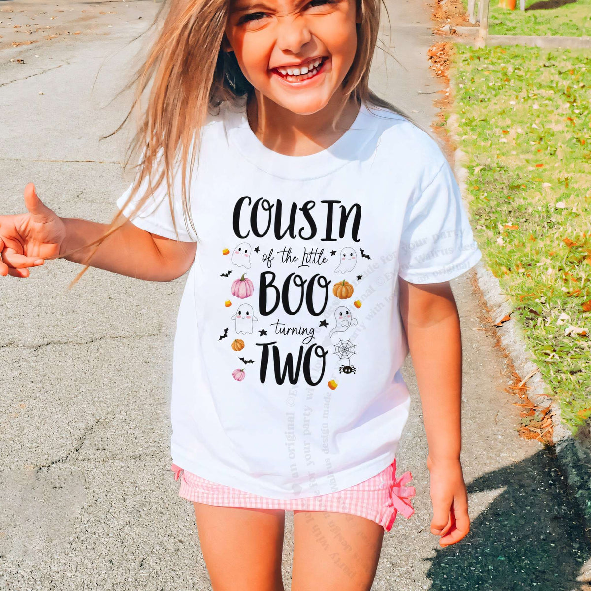 Laughing girl outdoors in a white Cousin of the Little Boo kids tee.