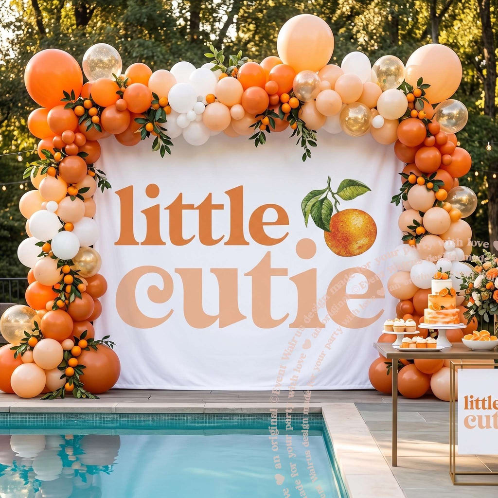 Little cutie clementine backdrop beside a pool framed by orange and white balloons and real oranges.