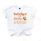White kids Brother of the Little Cutie tee with a clementine, laid flat.