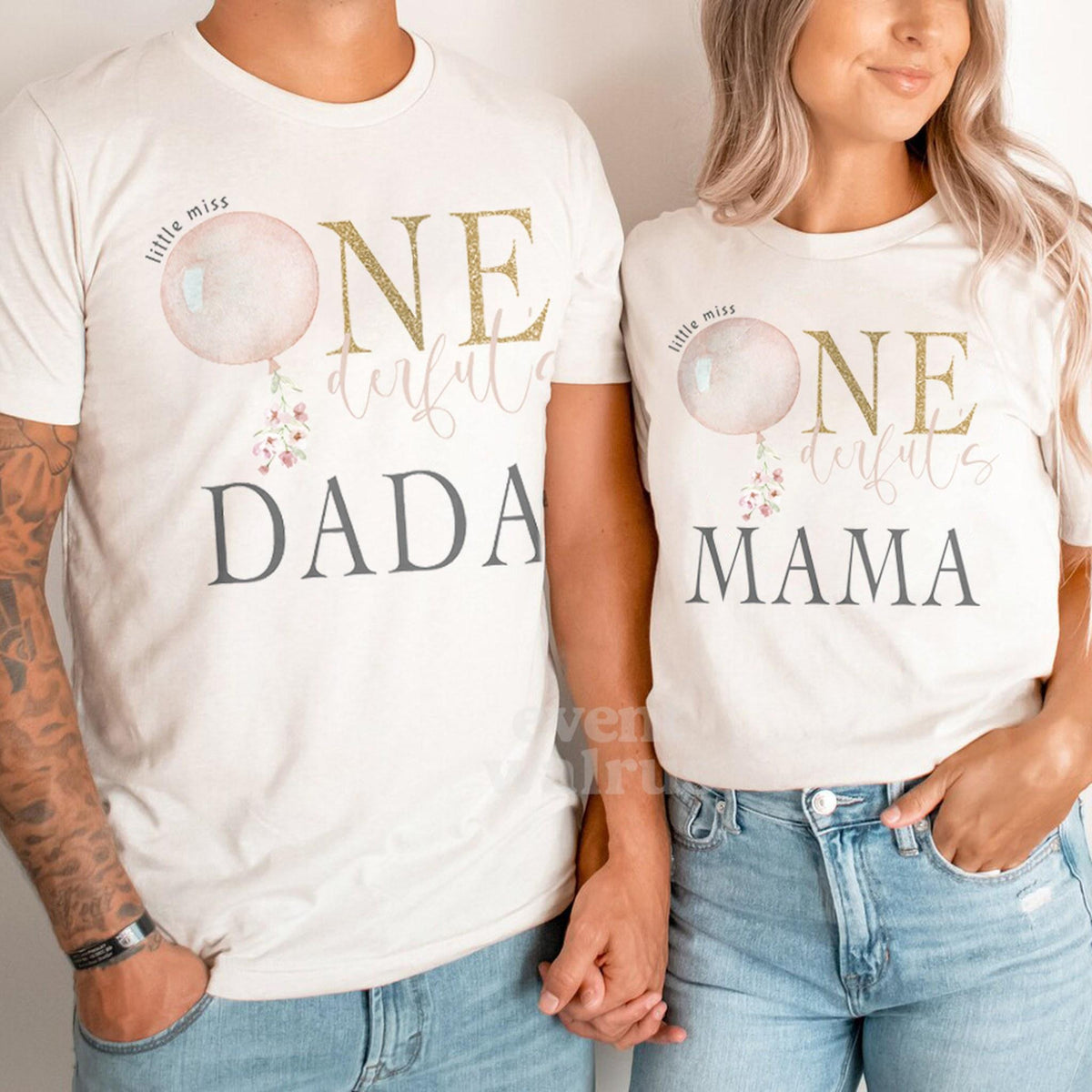Dad and Mom holding hands in matching Dada and Mama pink balloon ONE shirts.