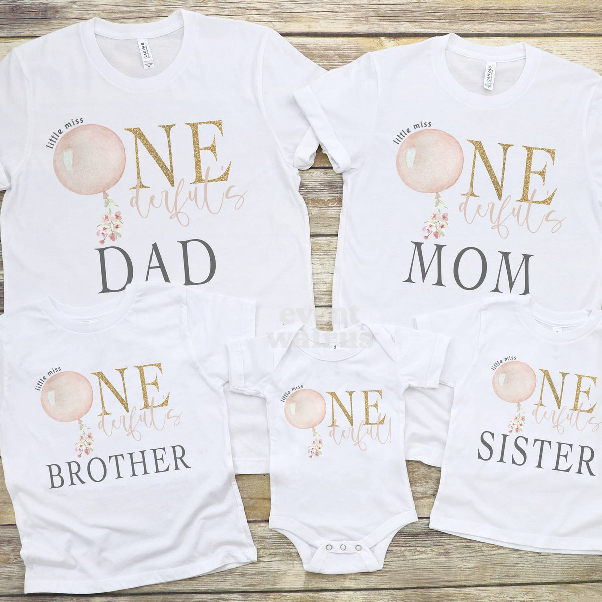 Family flat lay of Dad, Mom, Brother and Sister tees with a baby bodysuit in the pink balloon design.