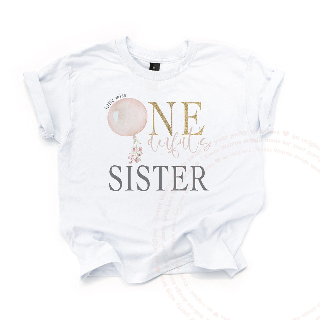 White Sister kids tee laid flat with the pink watercolor balloon and gold glitter ONE.