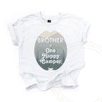 White Brother of One Happy Camper kids tee laid flat, with the misty mountain oval.