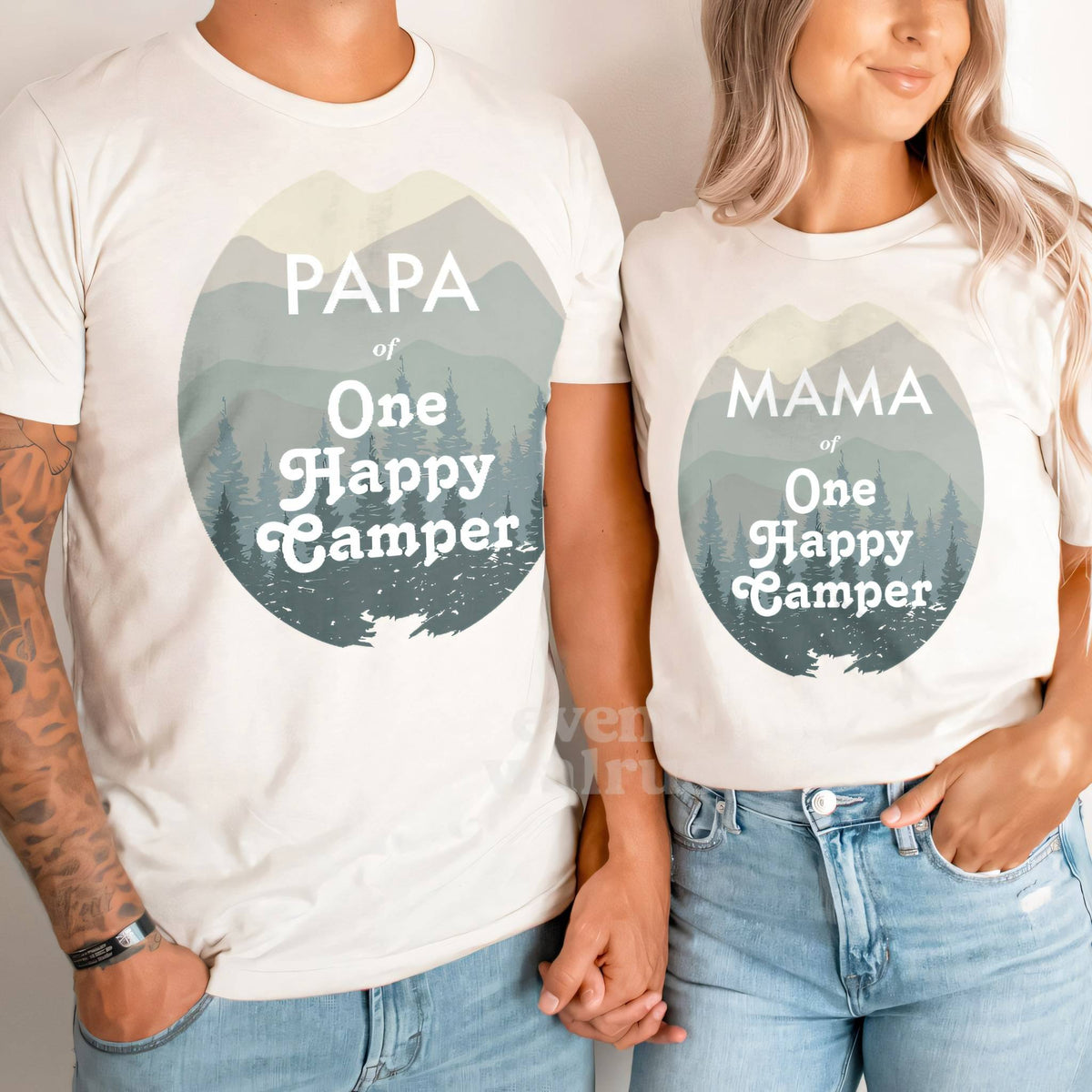 Dad and Mom holding hands in white Papa and Mama One Happy Camper shirts.