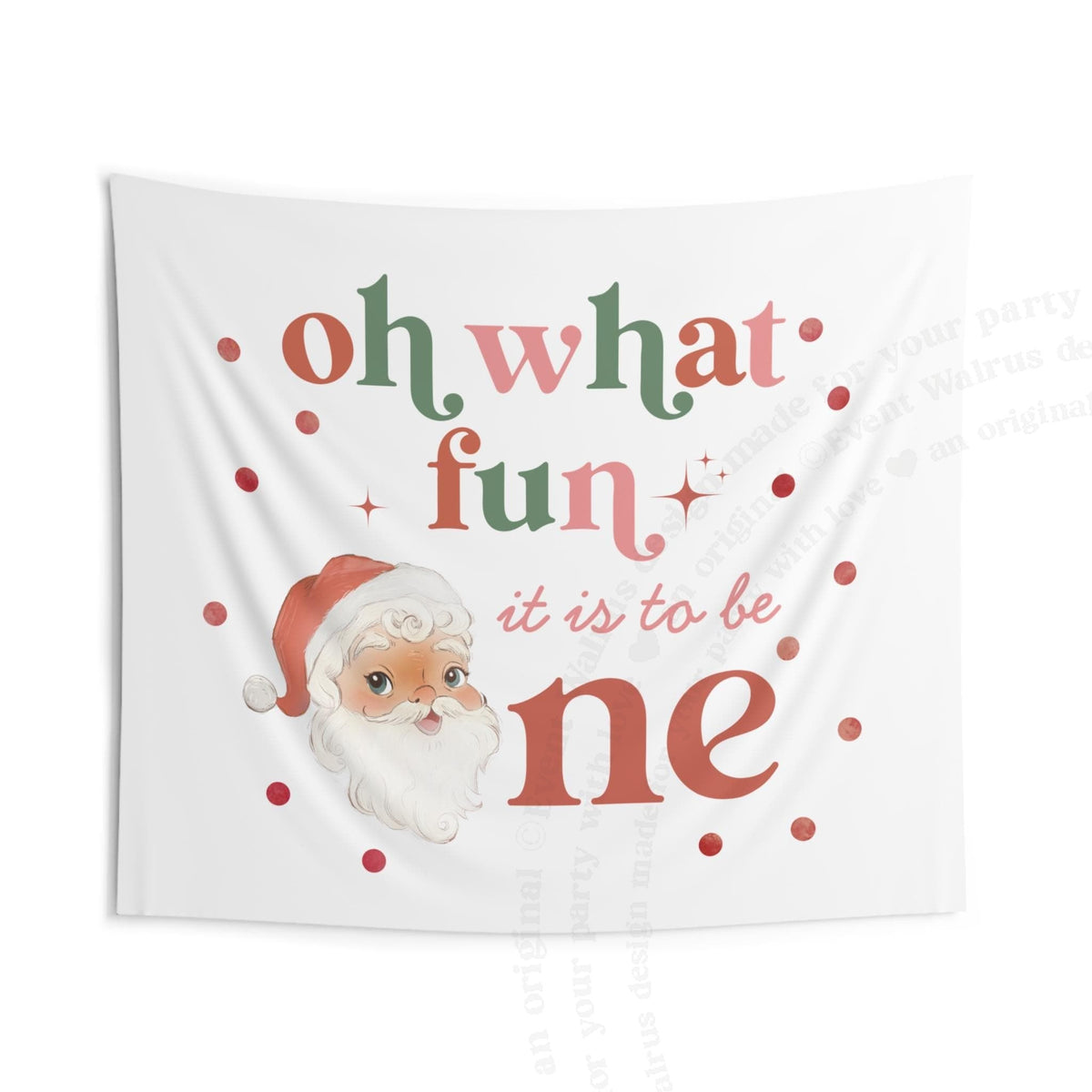 The oh what fun backdrop hanging flat, showing the terracotta, sage and pink lettering and polka dots.