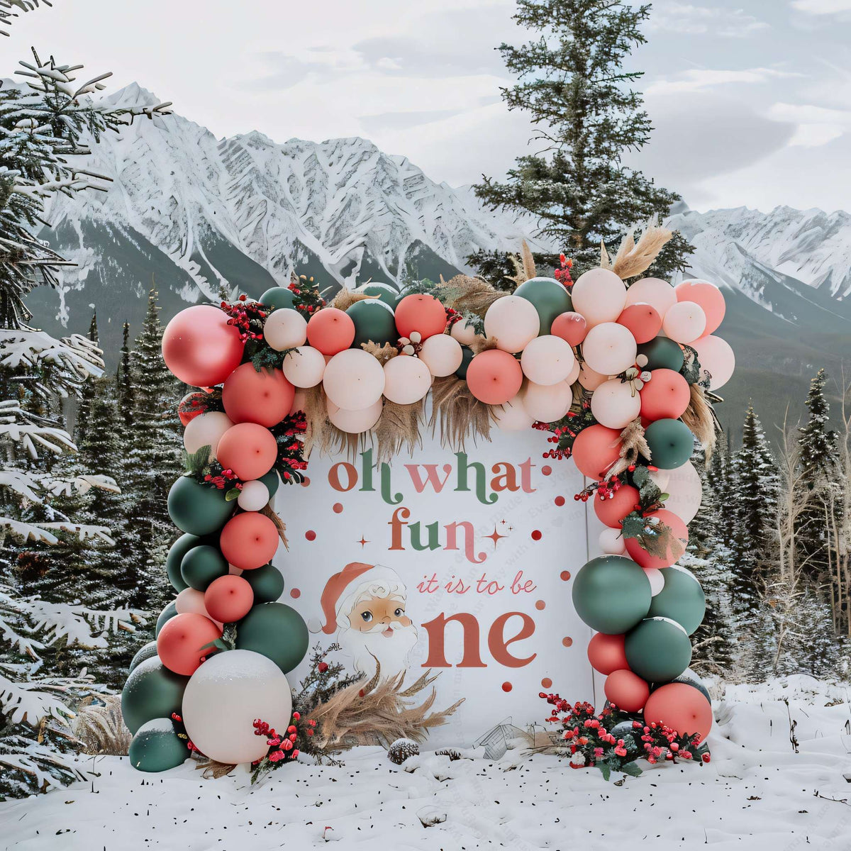 Vintage Santa first birthday backdrop topped with a balloon and pampas garland among snowy pines.