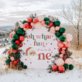 Oh what fun backdrop with a vintage Santa under a red, green and blush balloon arch in the snow.