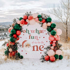 Oh what fun backdrop with a vintage Santa under a red, green and blush balloon arch in the snow.