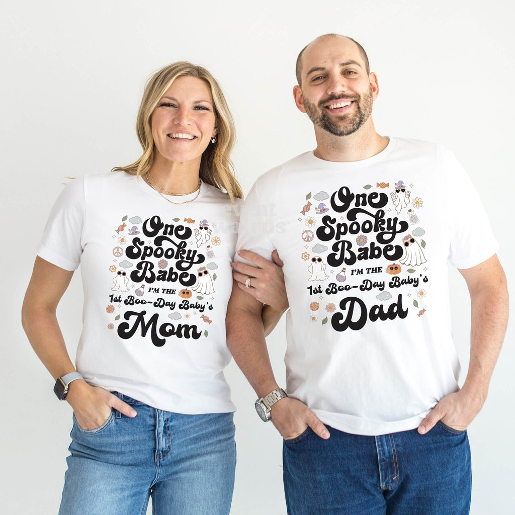 Mom and Dad standing together in white One Spooky Babe Mom and Dad shirts.