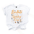 White Brother of the Spooky One kids tee laid flat, with a mummy, black cat and little ghost.
