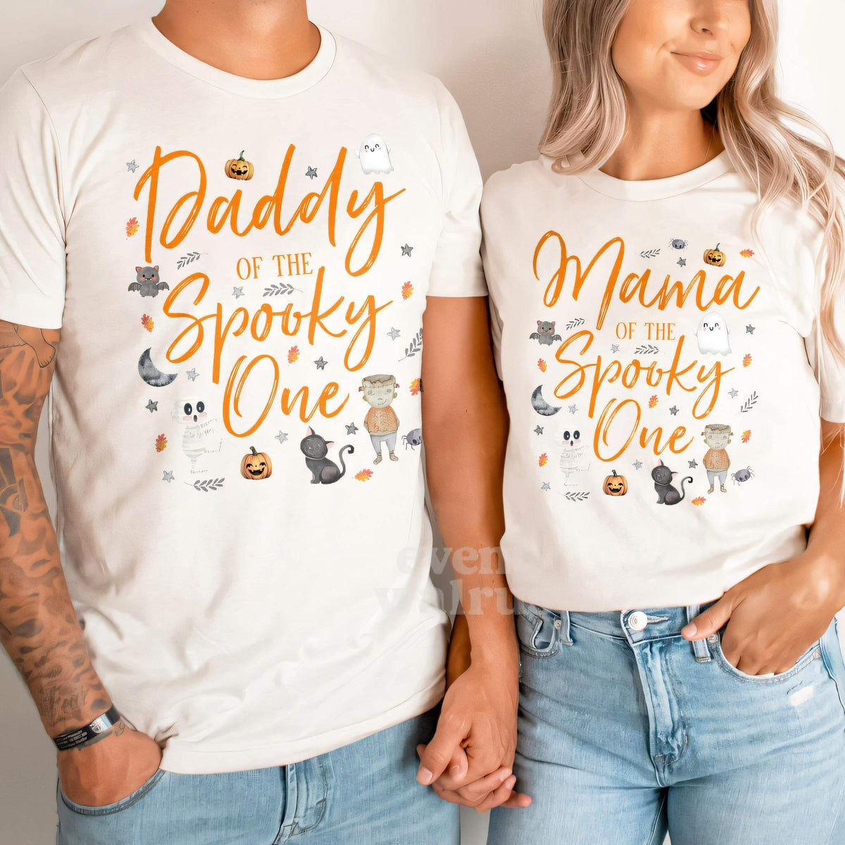 Dad and Mom holding hands in white Daddy and Mama Spooky One shirts.