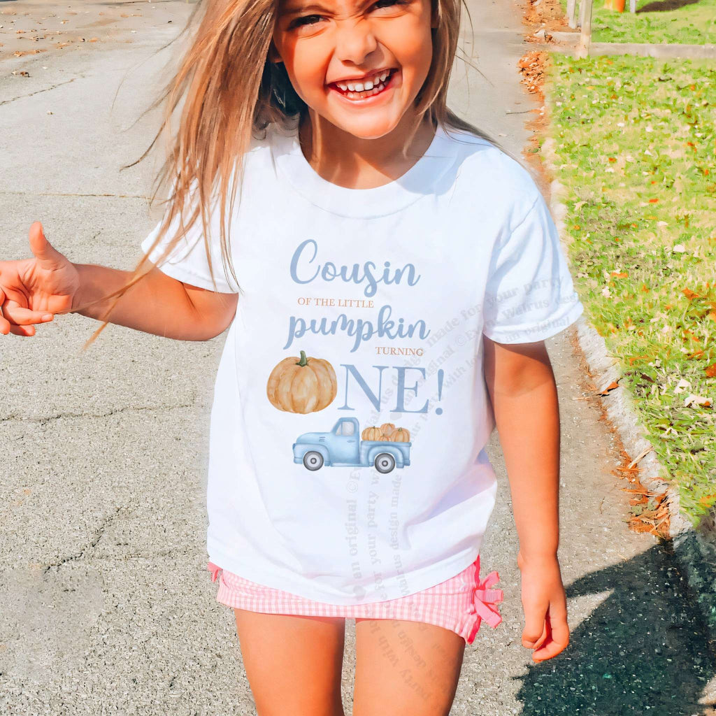 Laughing girl outdoors in a white Cousin of the Little Pumpkin kids tee.