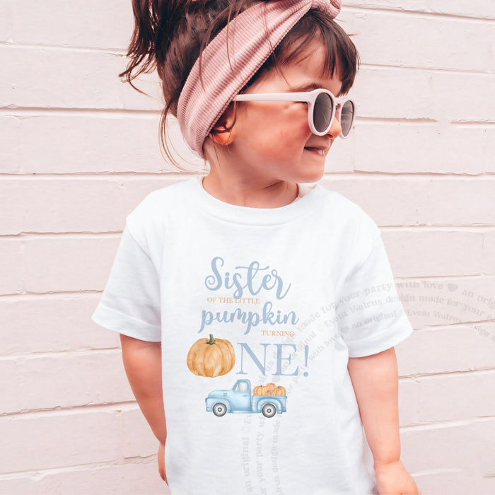 Girl in sunglasses and a pink headband wearing a white Sister of the Little Pumpkin shirt.