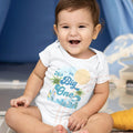 Smiling baby boy in a white I'm The Big One palm tree bodysuit.