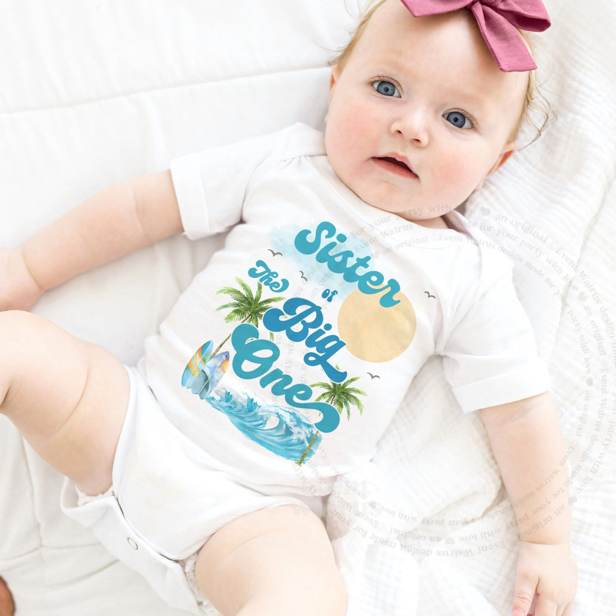 Baby girl with a pink bow in a white Sister of The Big One bodysuit.