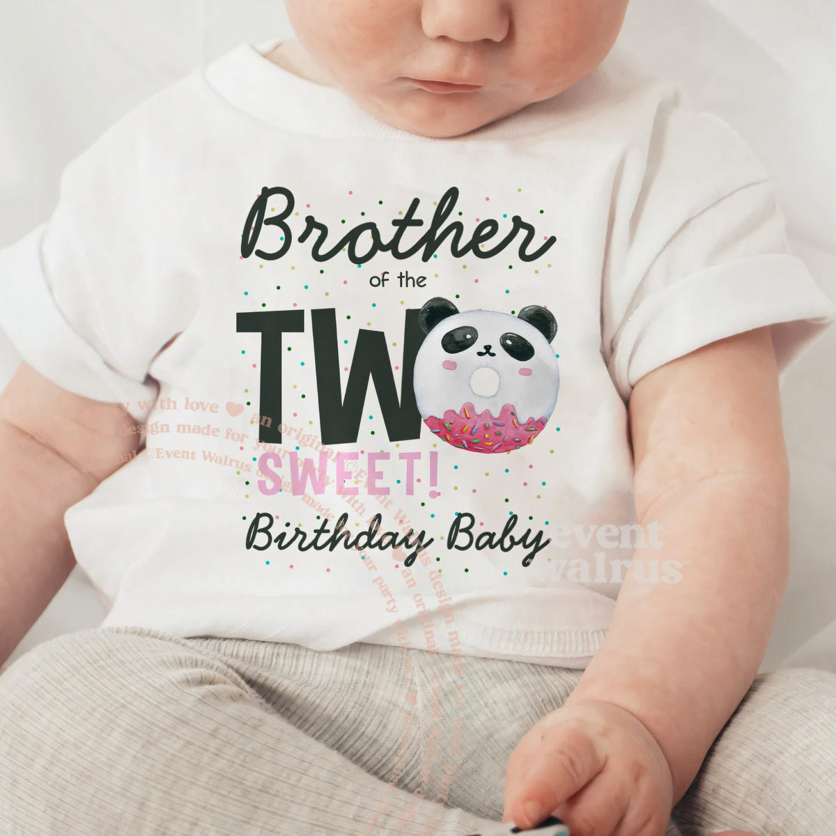 Baby sitting up in a white Brother of the Two Sweet baby tee.