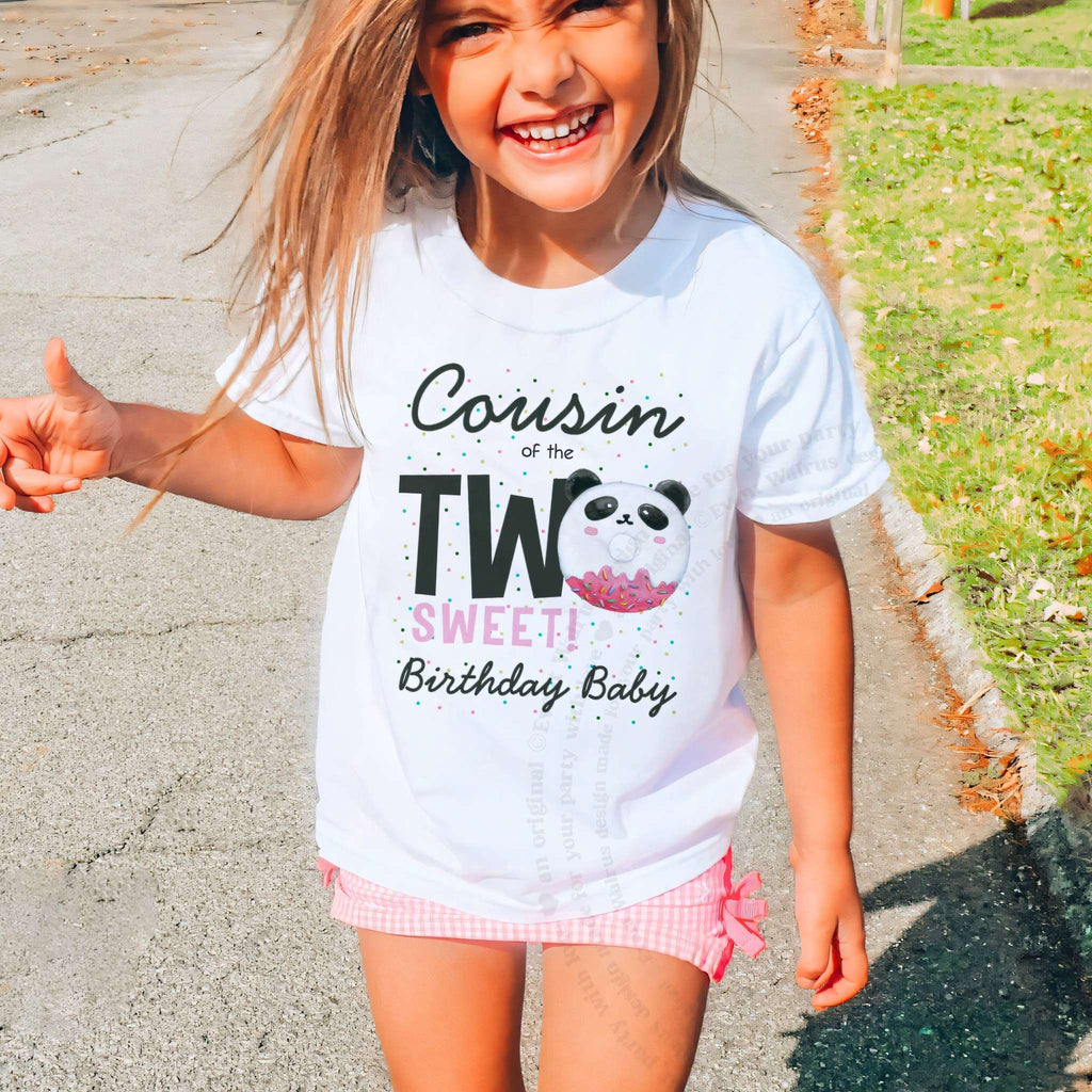 Laughing girl outdoors in a white Cousin of the Two Sweet kids tee.