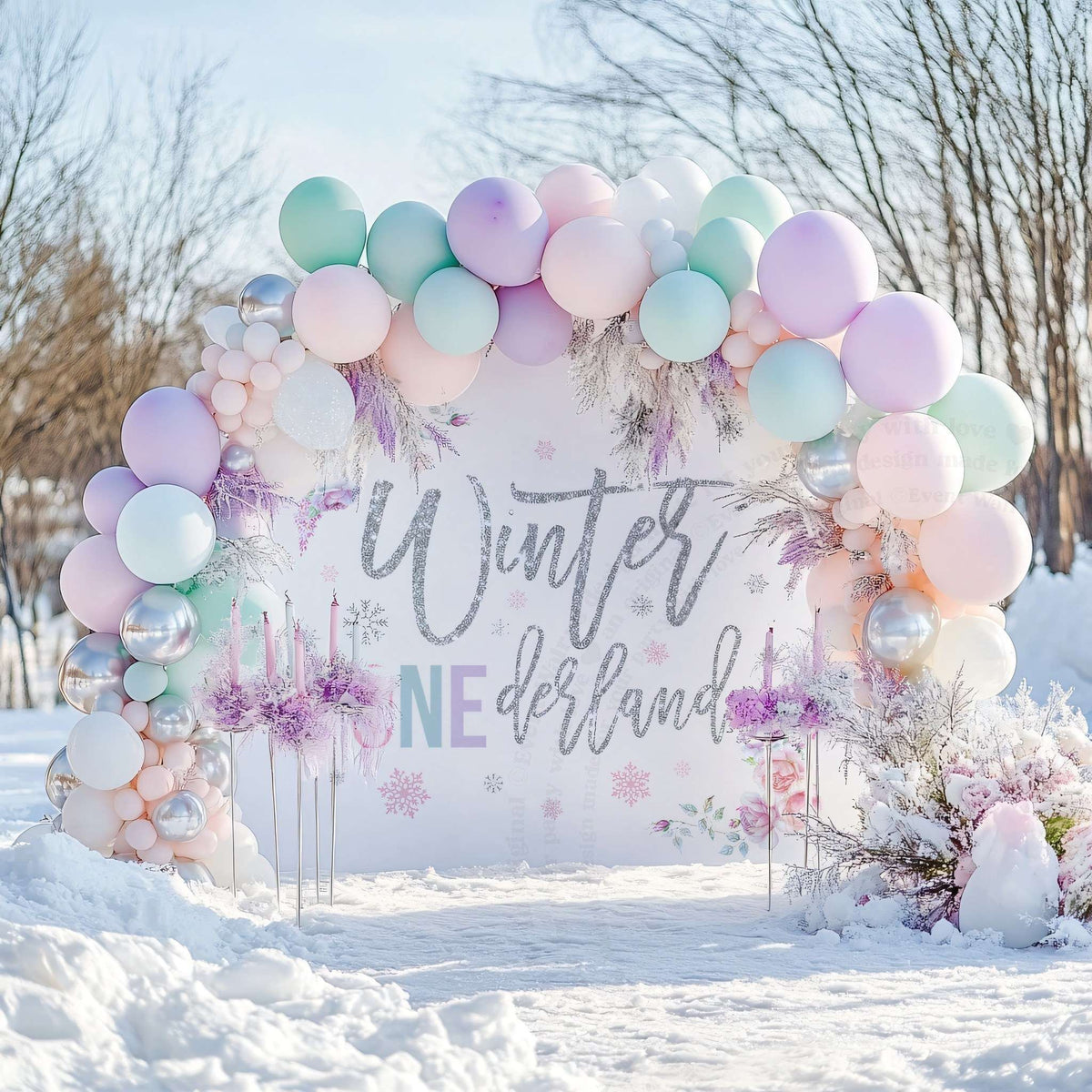 Winter onederland backdrop in a snowy yard under a pastel balloon arch with lavender flowers.