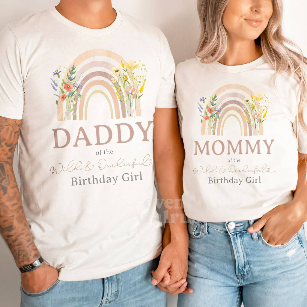 Couple in white Daddy and Mommy of the Wild and Onederful Birthday Girl shirts.
