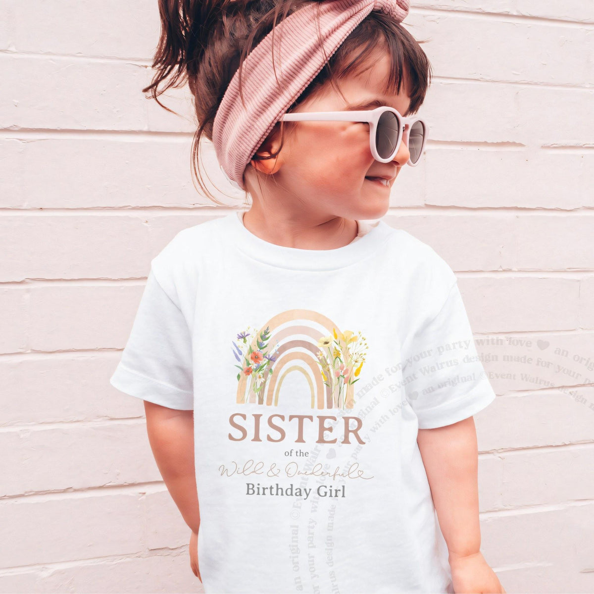 Girl in pink sunglasses wearing a white Sister of the Wild and Onederful Birthday Girl tee.