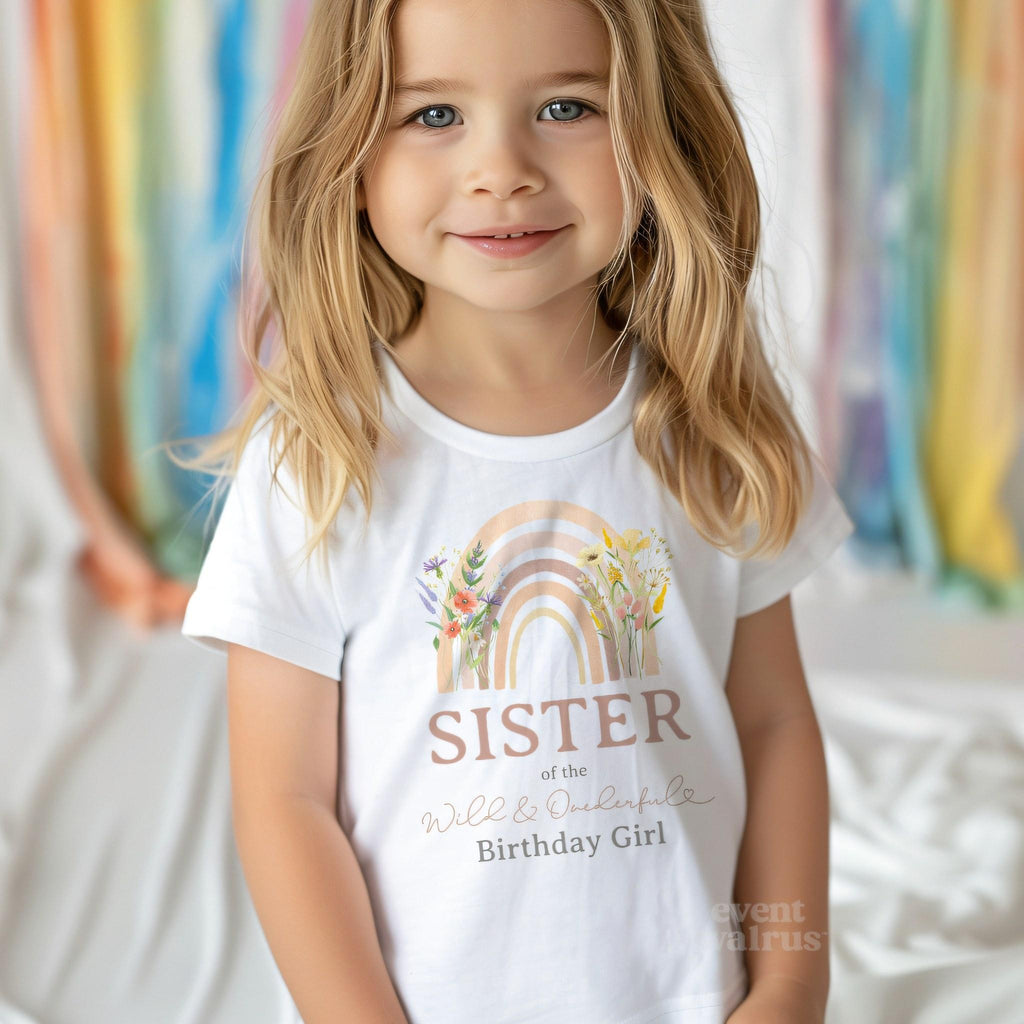 Little girl in a white Sister of the Wild and Onederful Birthday Girl shirt.