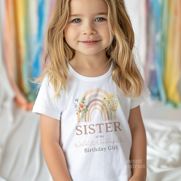 Little girl in a white Sister of the Wild and Onederful Birthday Girl shirt.
