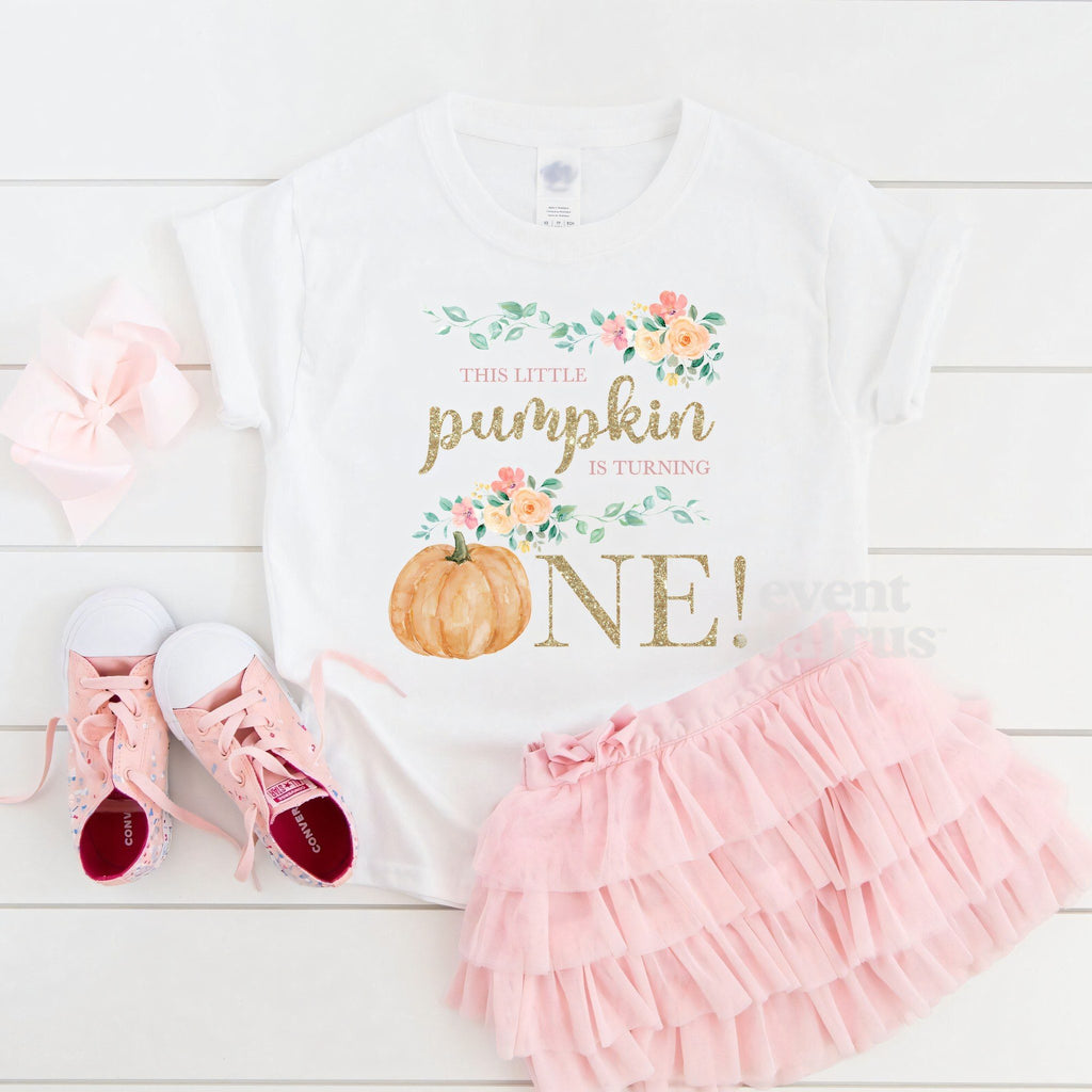 White floral Little Pumpkin toddler tee laid flat with a pink tutu and sneakers.