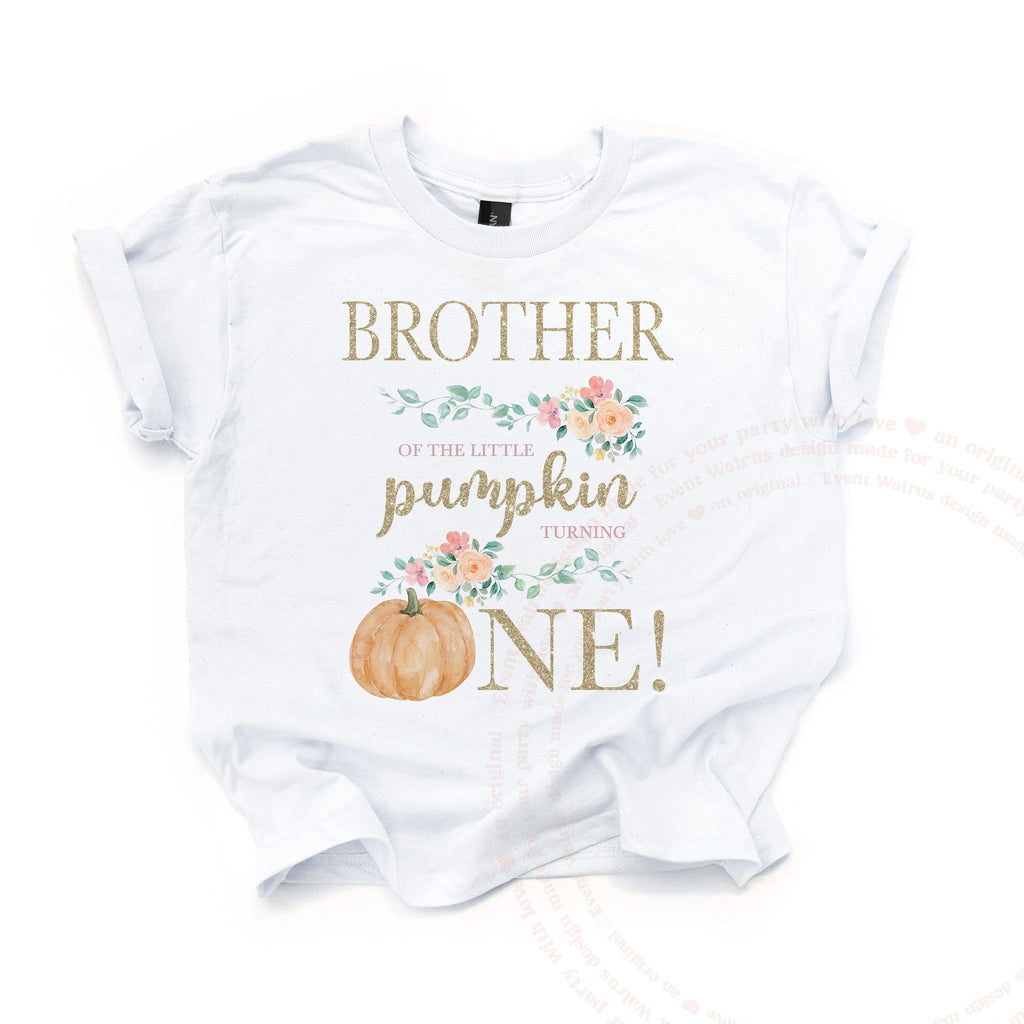 White Brother of the Little Pumpkin kids tee laid flat, with the peach pumpkin and gold glitter ONE.