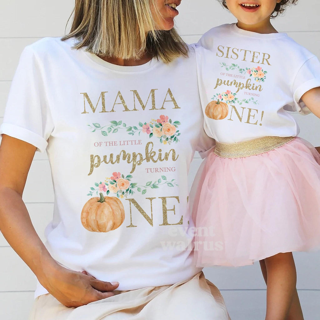 Mom holding hands with her little girl in a tutu, in white Mama and Sister Little Pumpkin shirts.