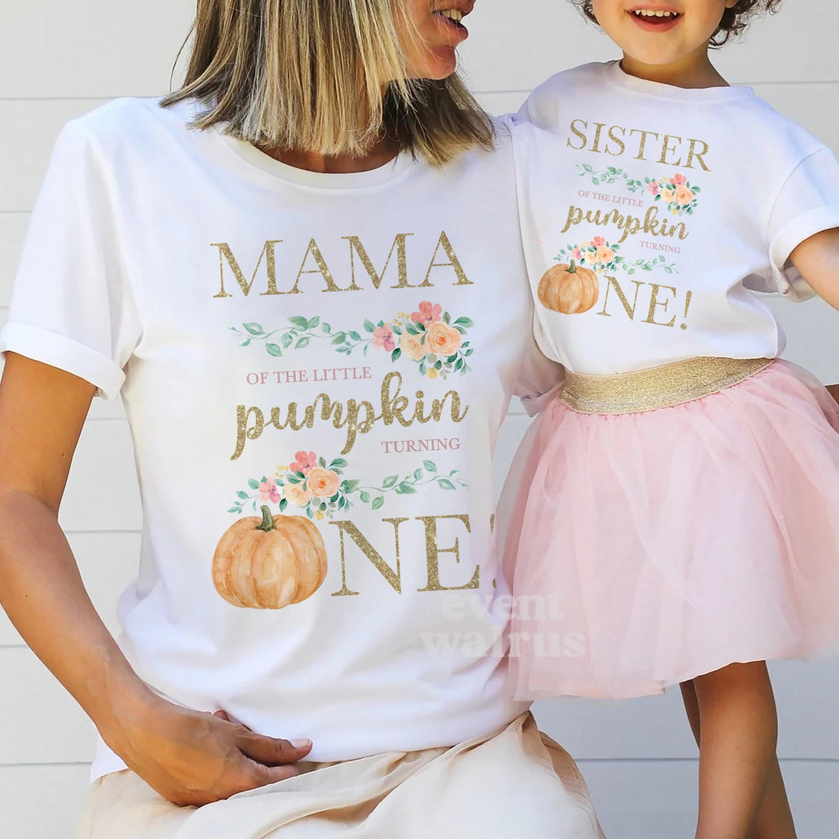 Mom holding hands with her little girl in a tutu, in white Mama and Sister Little Pumpkin shirts.