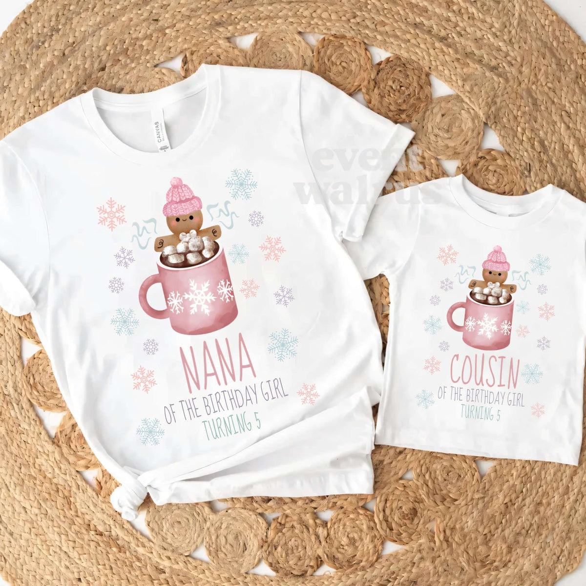 White Nana and Cousin pink Cookies and Cocoa tees on a round jute rug.