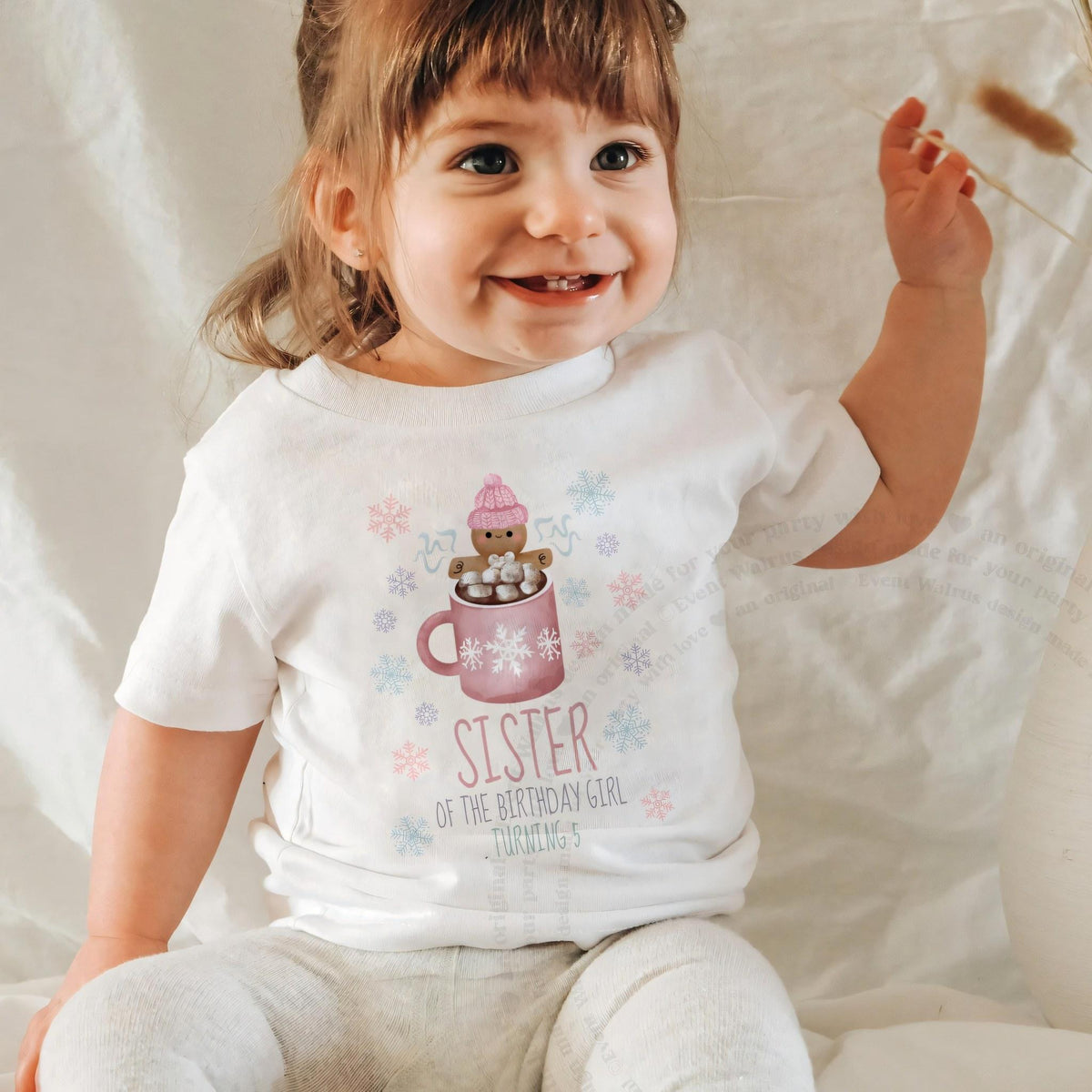 Laughing baby girl in a white Sister of the Birthday Girl baby tee.