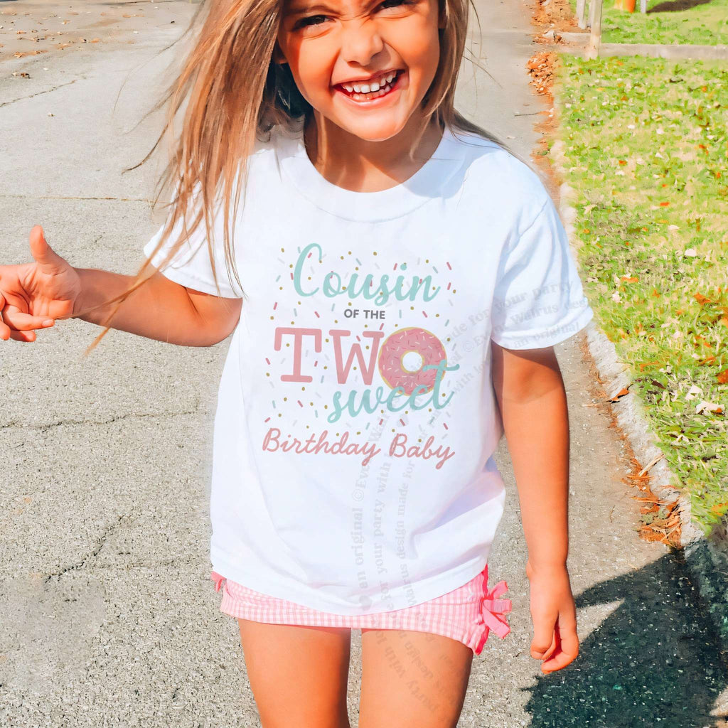 Laughing girl outdoors in a white Cousin of the Two Sweet kids tee.