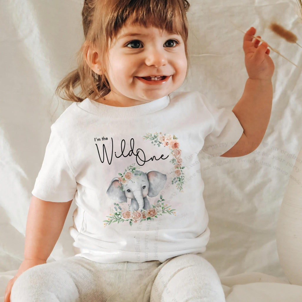 Laughing baby girl in a white I'm the Wild One baby tee with the watercolor elephant.