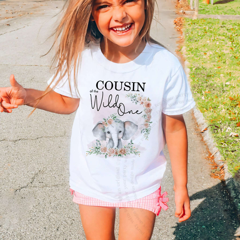 Laughing girl outdoors in a white Cousin of the Wild One kids tee.