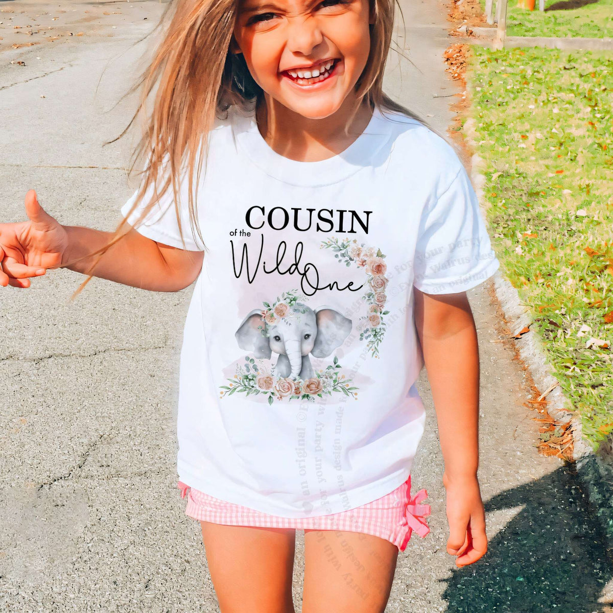 Laughing girl outdoors in a white Cousin of the Wild One kids tee.