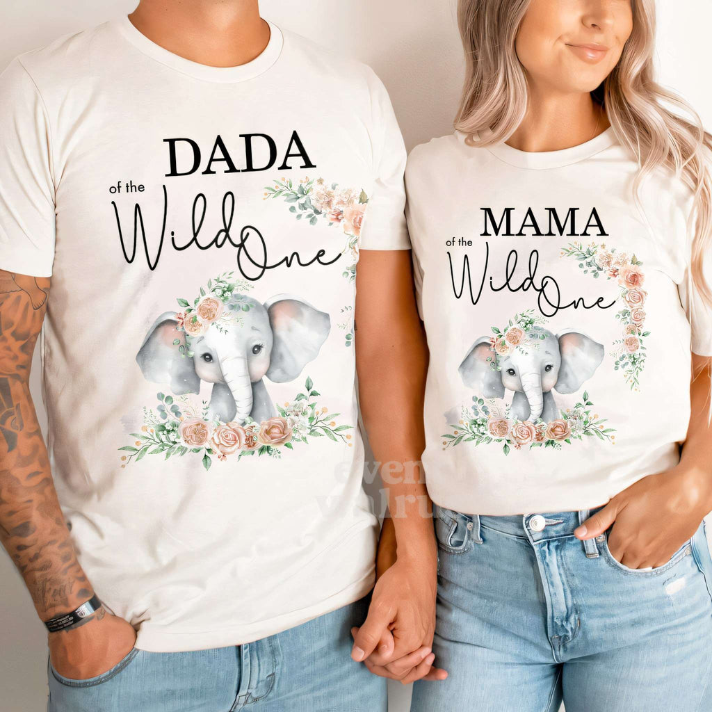 Dad and Mom holding hands in white Dada and Mama of the Wild One elephant shirts.