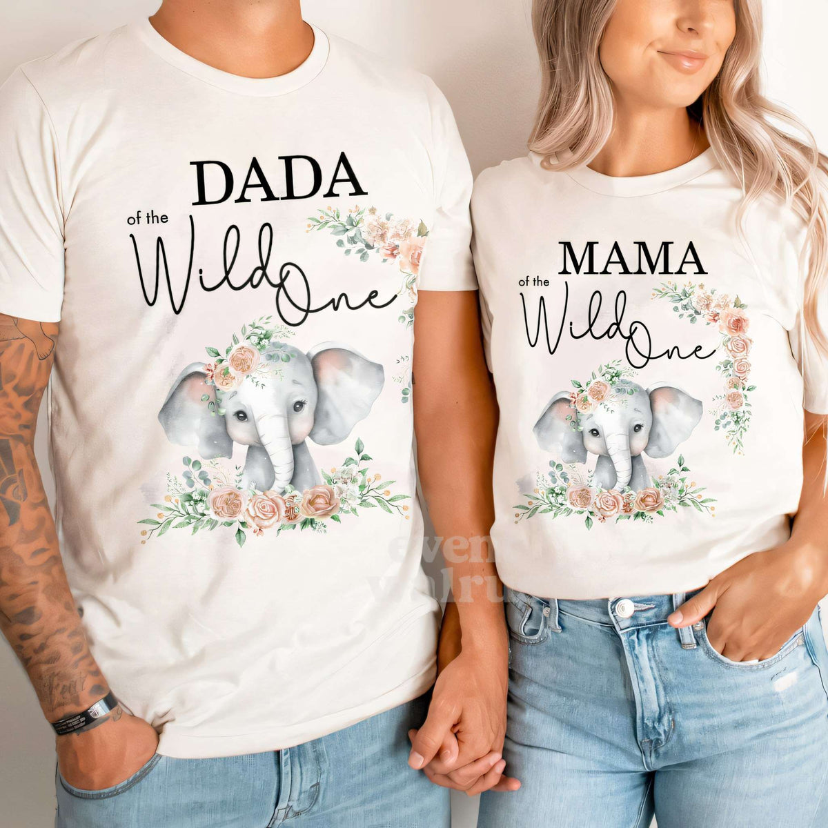 Dad and Mom holding hands in white Dada and Mama of the Wild One elephant shirts.