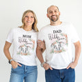 Mom and Dad standing together in white pink elephant Wild One shirts.