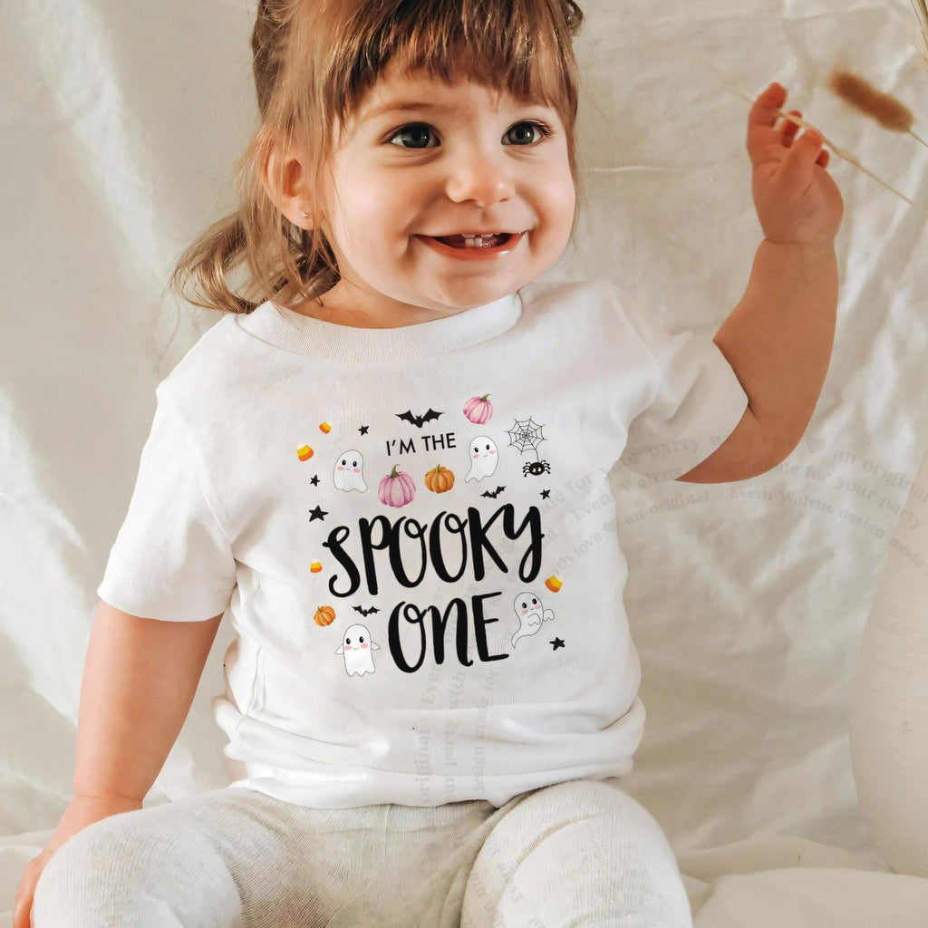 Laughing baby girl in a white I'm the Spooky One baby tee.
