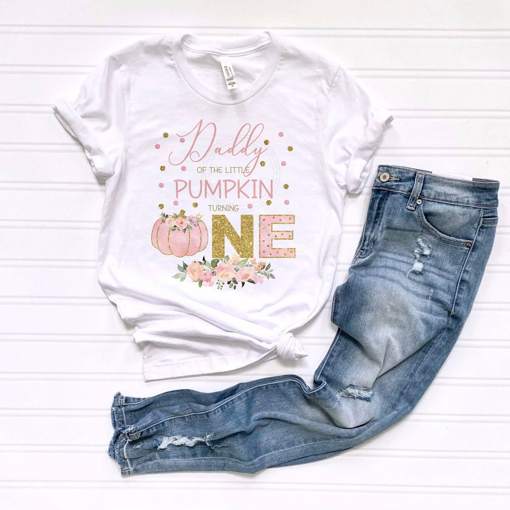 White Daddy of the Little Pumpkin tee laid flat beside jeans.