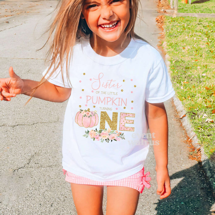 Laughing girl outdoors in a white Sister of the Little Pumpkin kids tee.