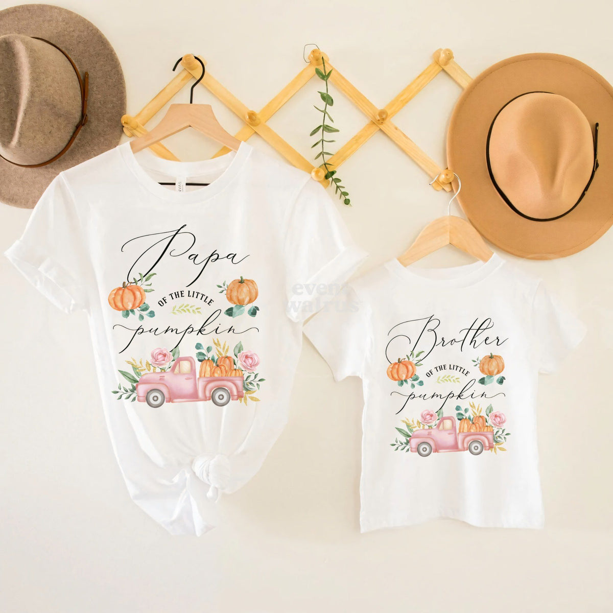 Brother of the Little Pumpkin tee hanging beside the Papa shirt on a peg rail.